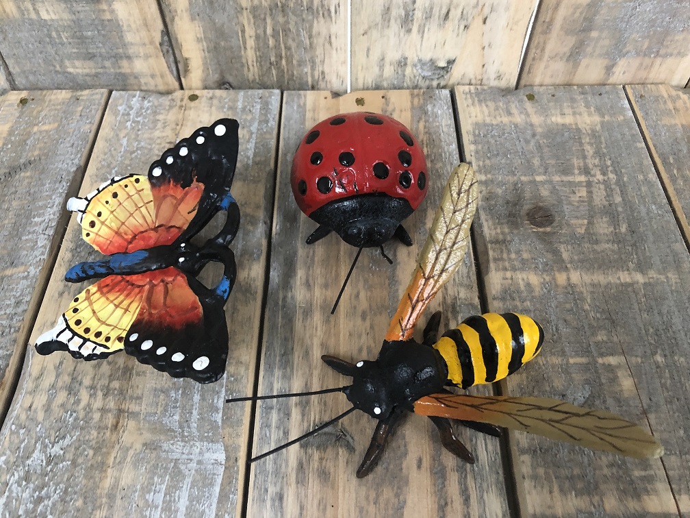 Cast iron figurines of a bee, butterfly and ladybird, full of colour.