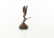 A bronze statue/sculpture of a stork figure