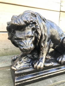 A beautiful statue of a lion with its prey, a boar, made of cast iron, bronze look!