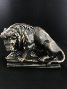 A beautiful statue of a lion with its prey, a boar, made of cast iron, bronze look!