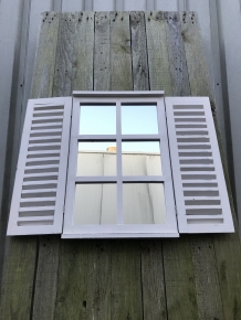  A mirror with hinged doors, made of wood