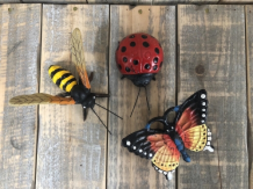 Cast iron figurines of a bee, butterfly and ladybird, full of colour.
