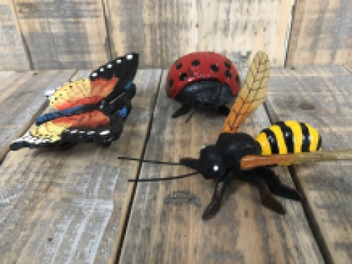 Cast iron figurines of a bee, butterfly and ladybird, full of colour.