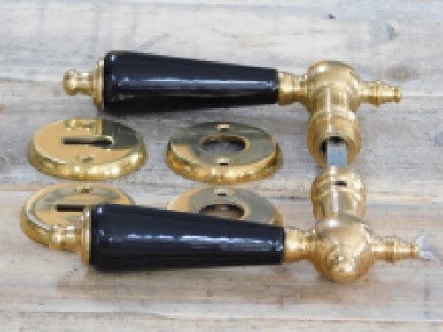 Set of door handles with rosettes - polished brass - with black ceramic handles