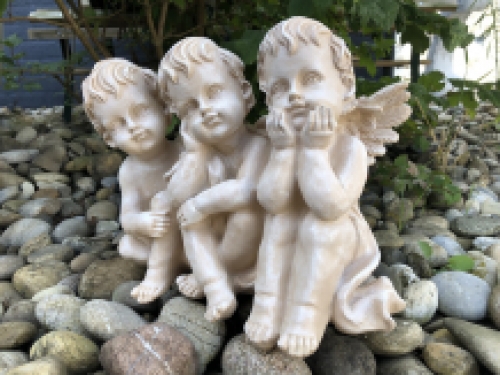 3 angels sitting in 1 row, very beautiful statue.