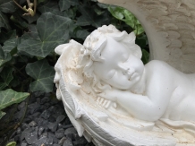 Statue of an angel sleeping in his wings, made of polystone