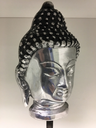 Buddha head on metal tripod, aluminum.