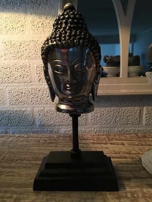 Buddha head on metal tripod, aluminum.