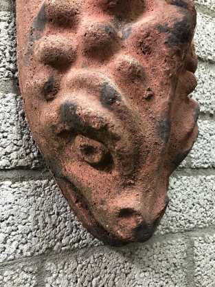 Wind light from roof tile with mythical image, with candlestick.