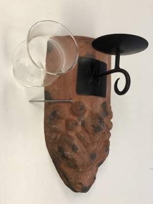 Wind light of roof tile with mythical image, with candlestick and glass flask.