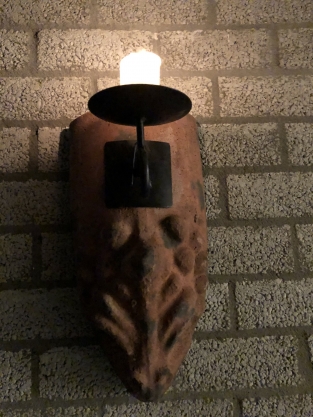 Wind light from roof tile with mythical image, with candlestick.