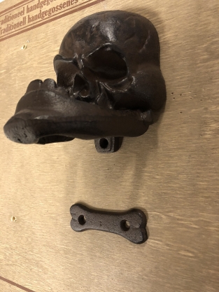 Cast iron brown skull as door knocker.