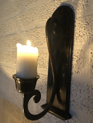 Beautiful dark brown heavy wrought iron wall sconce.