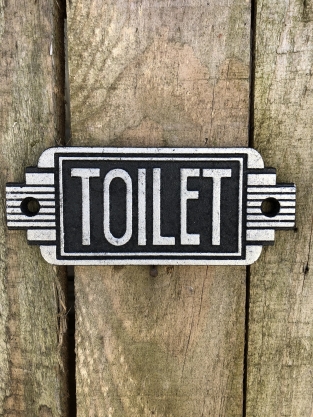Cast iron sign 'Toilet' in front of door