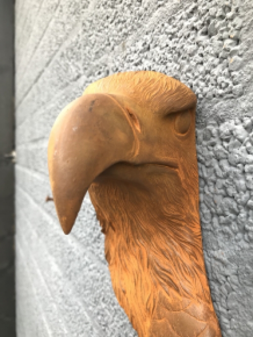 Eagle's head, cast iron wall ornament with rustic surface