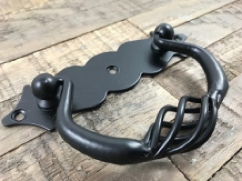 A door handle made of wrought iron, with beautifully turned handle, matt black