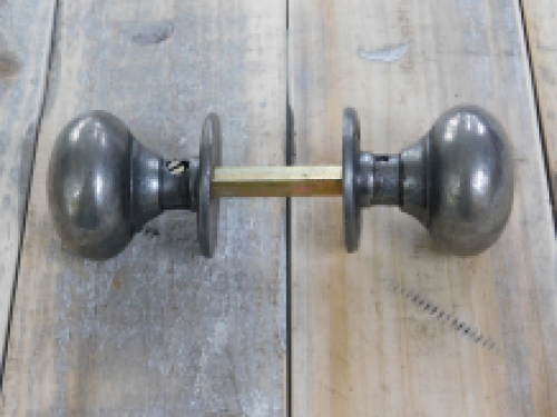 Een deurknop set met twee deurknoppen en twee rozetten, draaibaar.
