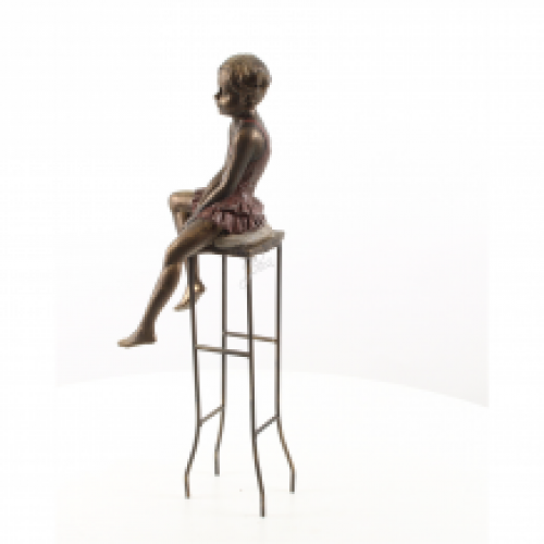 Polystone statue of a little girl on a chair.