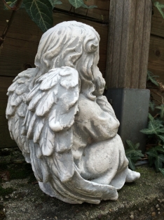 Angel sitting full of stone, beautiful in detail.