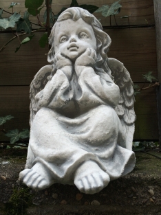 Angel sitting full of stone, beautiful in detail.