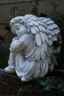 Beautiful sitting angel, full of detail, full of stone.