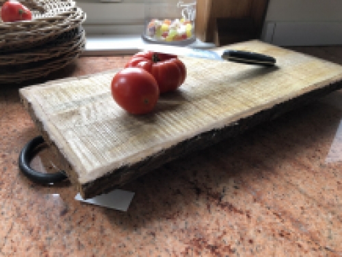 Beautiful rustic cutting board made of solid wood, nostalgic kitchen board, with metal brackets.