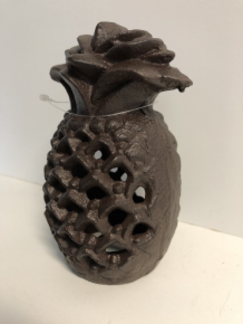 Cast iron lantern in the shape of a pineapple, atmospheric lighting.