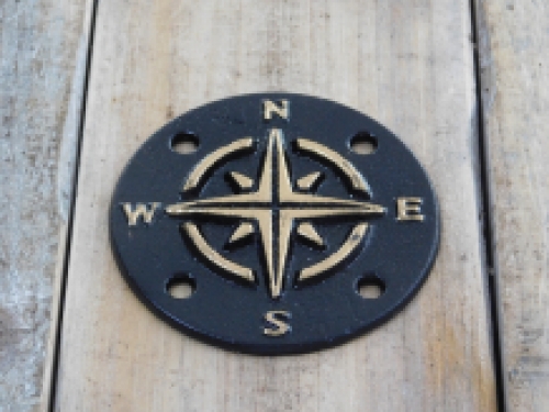 A cast iron plate as a compass for example on the wall