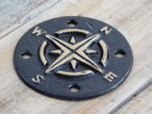 A cast iron plate as a compass for example on the wall