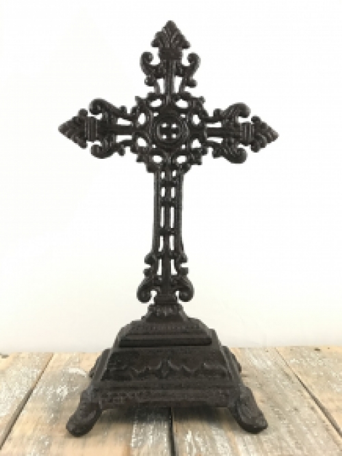 A cross on a stand made of cast iron