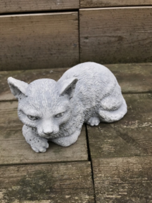 A beautiful lying cat, made of stone, beautiful in detail