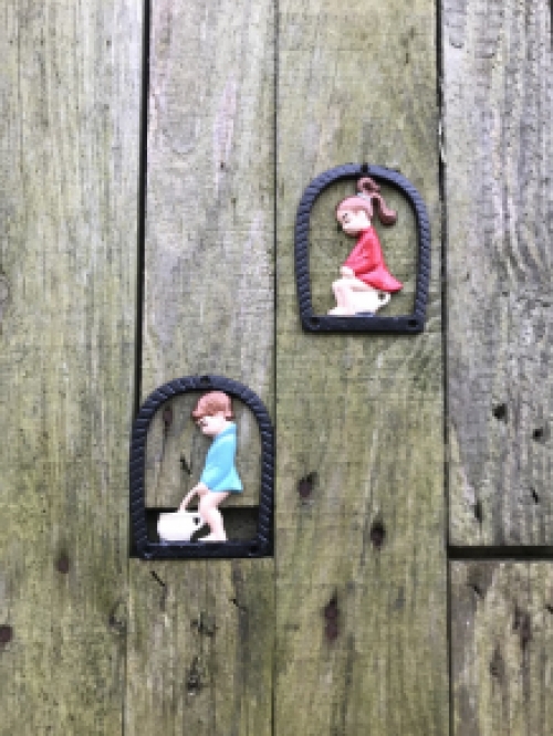 Set of toilet signs of a boy and a girl, metal in color