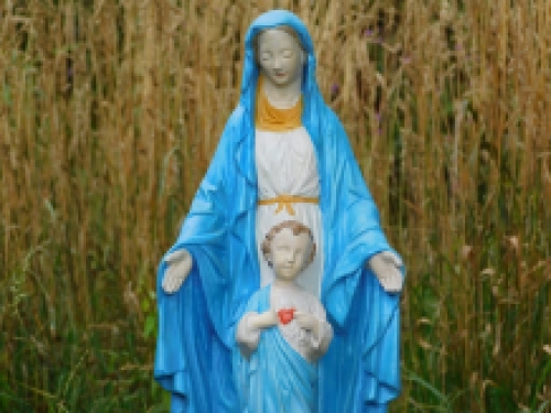 Mary with Jesus' sacred heart, full of stone church statue.