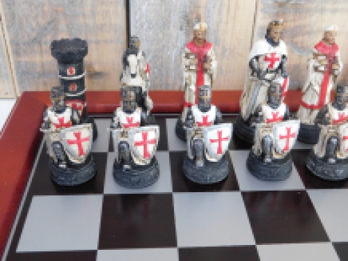 A chess game with the theme: ''MEDIEVAL KNIGHTS'', beautiful chess pieces like medieval knights on a wooden chessboard.