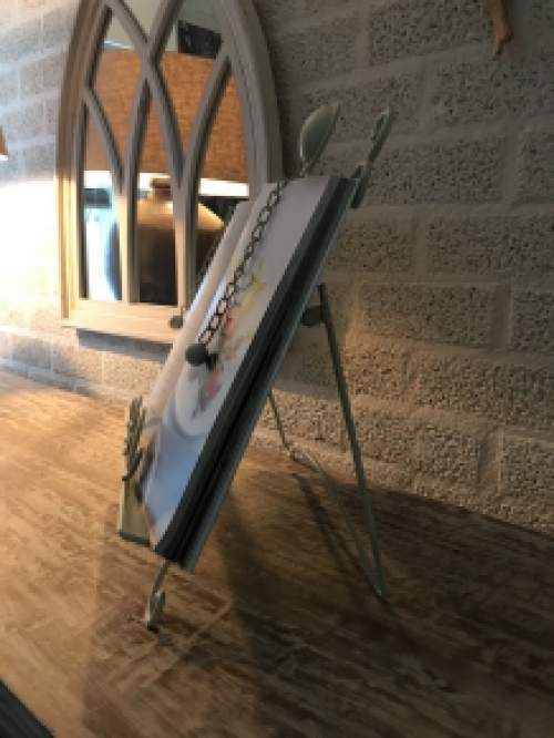 A white stand / holder for pieces of music, menus and, for example, books