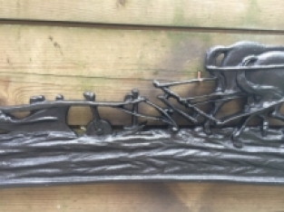 Wall decoration , cast iron black fireplace plate farmer with horse and plow.