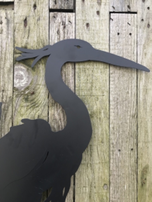A silhouette of a heron, matte black