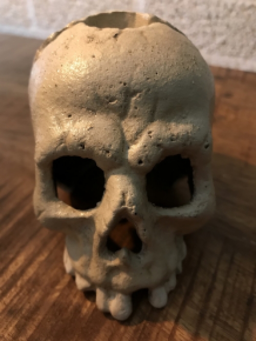 Skull as a candlestick, candle holder as a skull