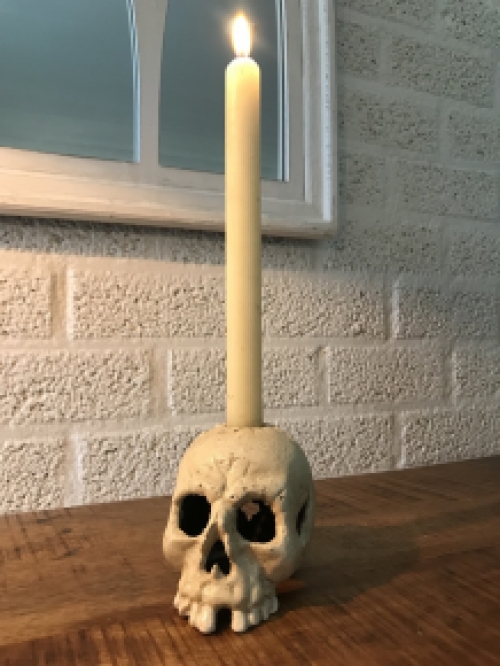 Skull as a candlestick, candle holder as a skull