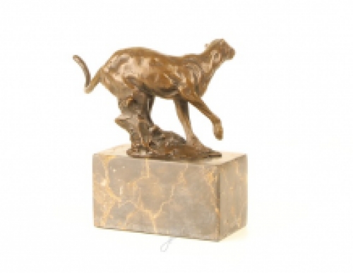 A bronze statue/sculpture of a running puma