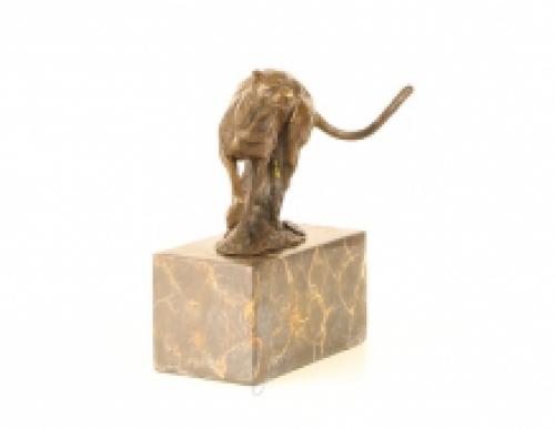 A bronze statue/sculpture of a running puma