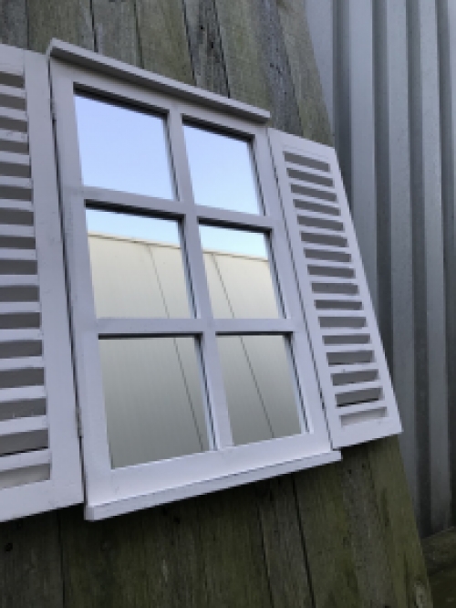  A mirror with hinged doors, made of wood