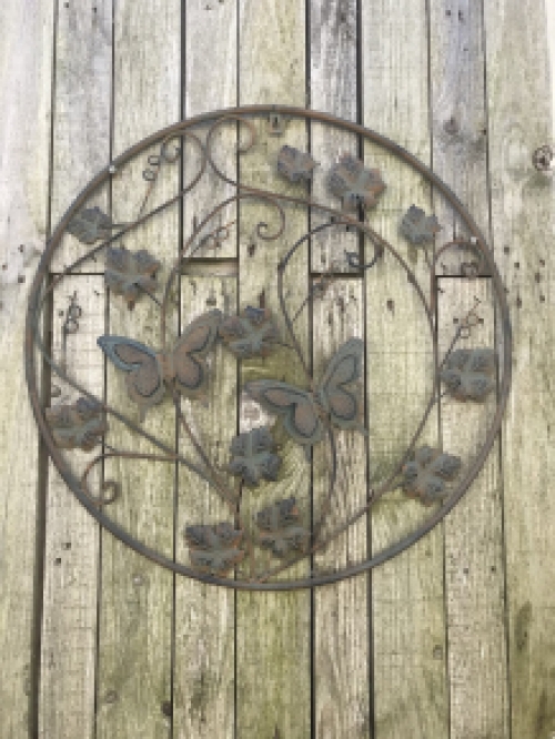 A metal wall ornament with leaves and butterflies, very decorative!