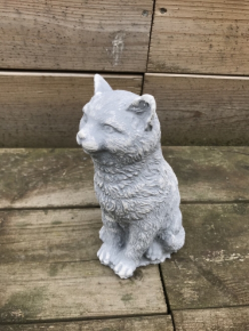 A beautiful sitting cat, made of stone, beautiful in detail